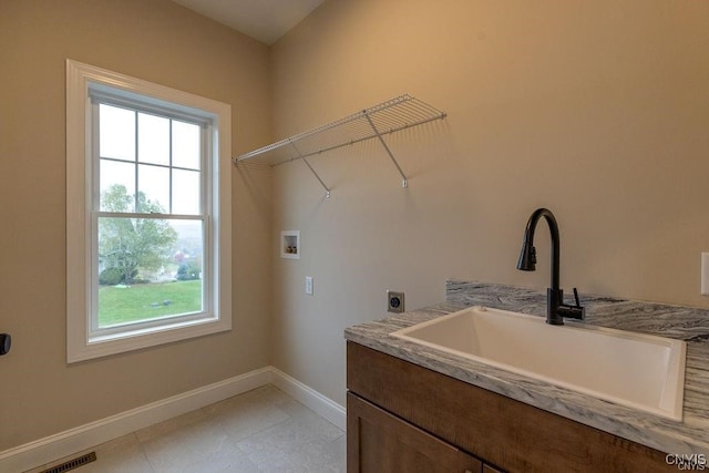 laundry room with hookup for a washing machine, sink, cabinets, electric dryer hookup, and light tile patterned flooring