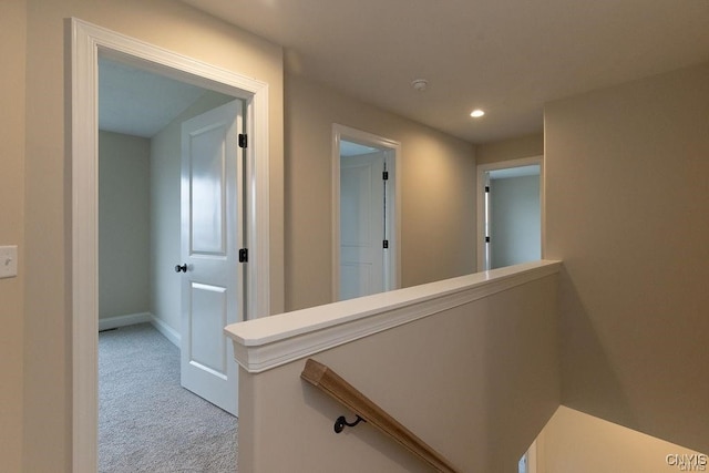 hallway with light colored carpet