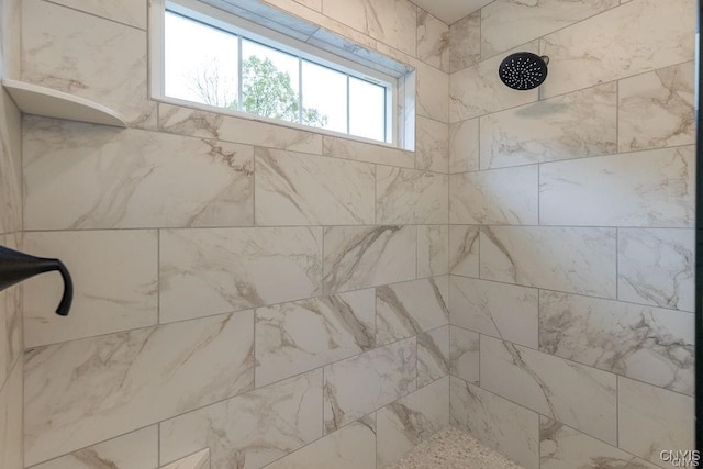 bathroom with a tile shower