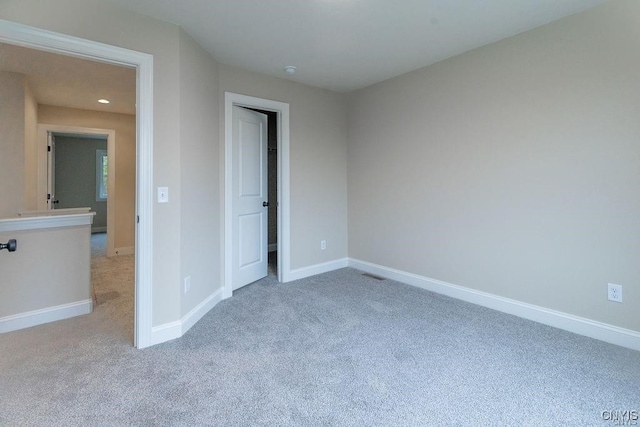 unfurnished bedroom featuring light carpet