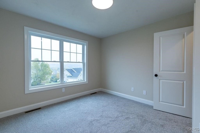 empty room featuring light carpet