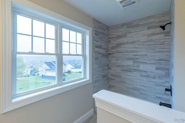 bathroom with tiled shower