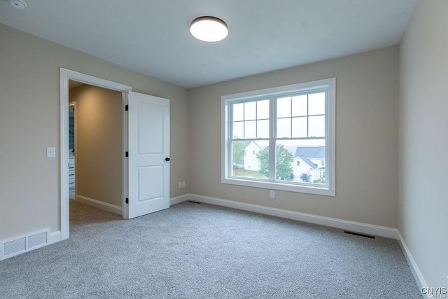 carpeted empty room featuring a healthy amount of sunlight