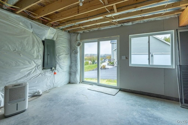 unfurnished room featuring concrete flooring and electric panel