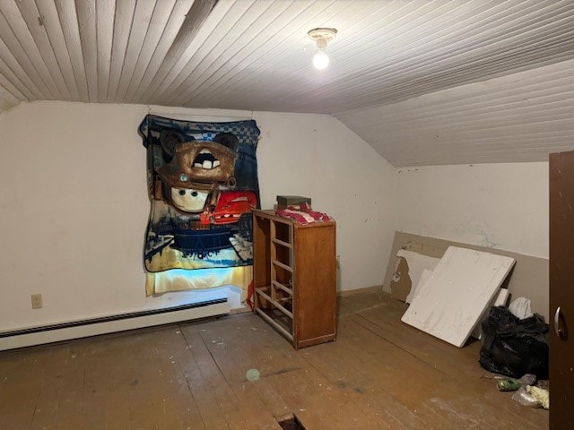 bonus room with lofted ceiling, a baseboard heating unit, and hardwood / wood-style flooring