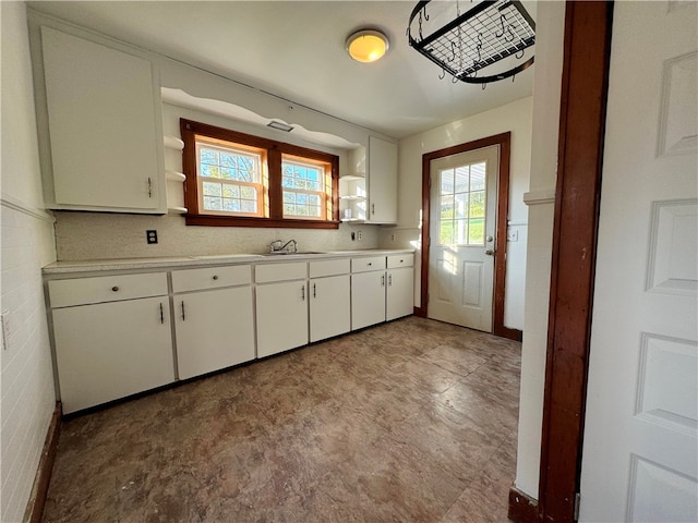 kitchen with sink, white cabinetry, and light tile patterned floors