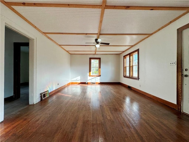 spare room with baseboards, visible vents, a ceiling fan, dark wood-style flooring, and crown molding