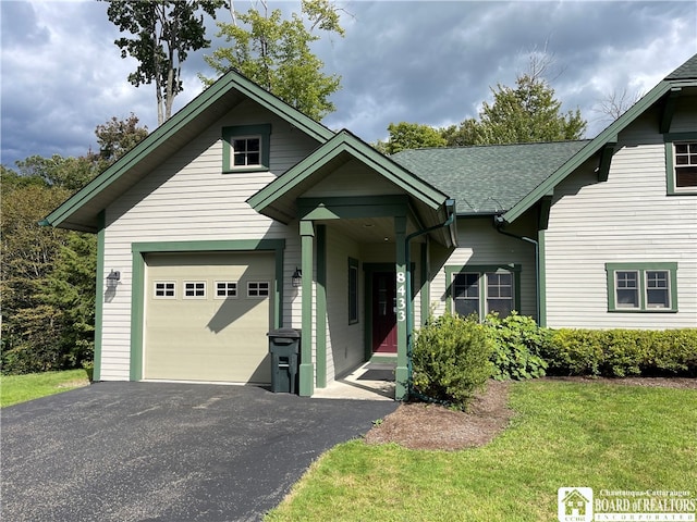 view of front of house with a garage and a front lawn