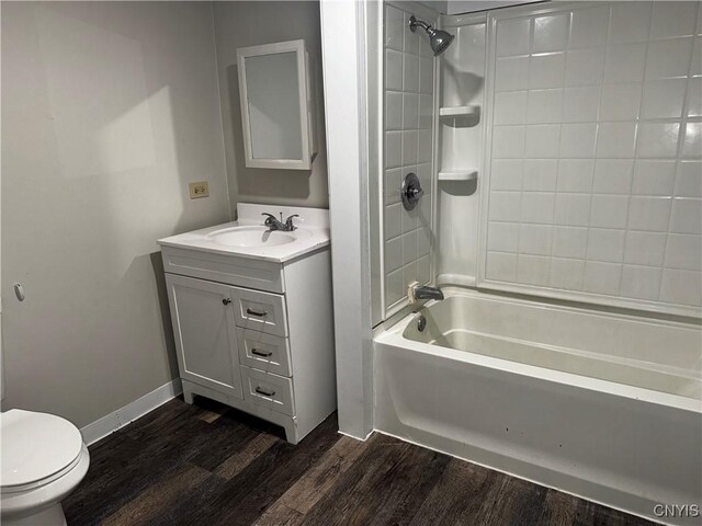 full bathroom with vanity, toilet, hardwood / wood-style flooring, and tiled shower / bath