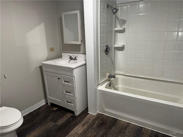 full bathroom featuring toilet, wood finished floors, vanity, baseboards, and shower / bathing tub combination