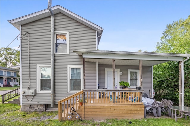 back of property featuring covered porch