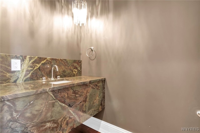 interior details featuring sink and decorative backsplash