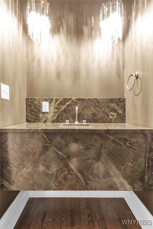 bathroom featuring hardwood / wood-style flooring, sink, and a chandelier