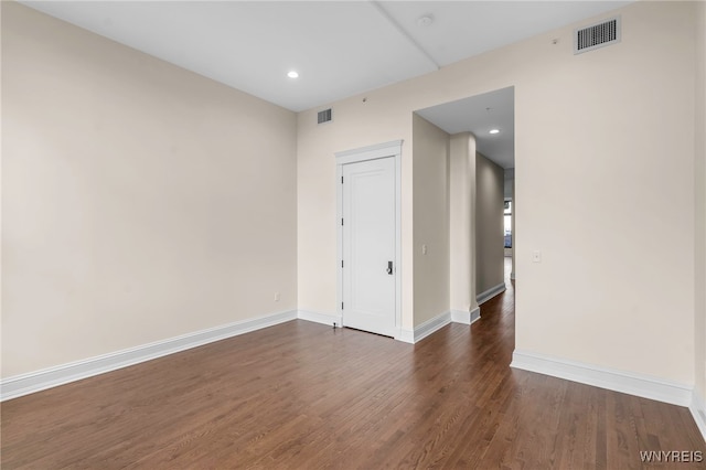 empty room featuring dark wood-type flooring