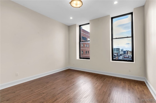 unfurnished room with hardwood / wood-style flooring