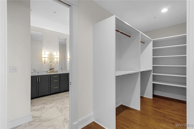 walk in closet featuring hardwood / wood-style flooring and sink