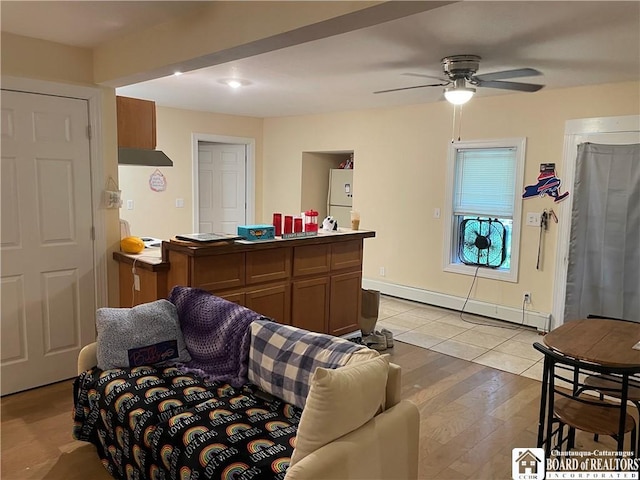 14 E Maple St N, Ellery, NY 14712 - living room with a ceiling fan, a baseboard heating unit, and light wood finished floors