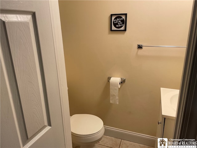 bathroom with vanity, toilet, and tile patterned floors