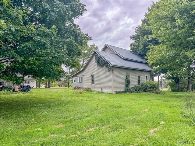 view of side of property with a lawn