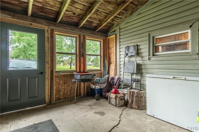 unfurnished sunroom with lofted ceiling