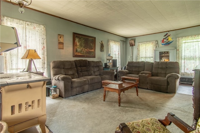 carpeted living room with a healthy amount of sunlight and ornamental molding