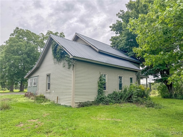 view of side of home featuring a yard