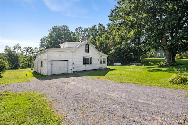 view of home's exterior featuring a lawn and a garage