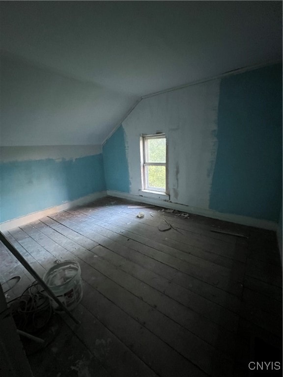 additional living space featuring lofted ceiling and wood-type flooring