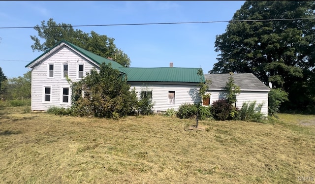 view of side of home with a lawn