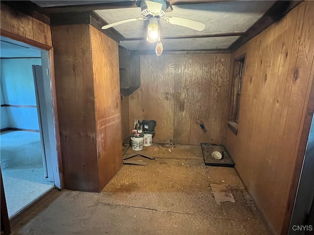 misc room featuring wooden walls and ceiling fan