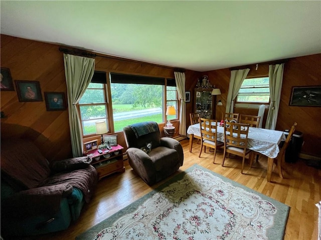 living room with wood walls and hardwood / wood-style floors