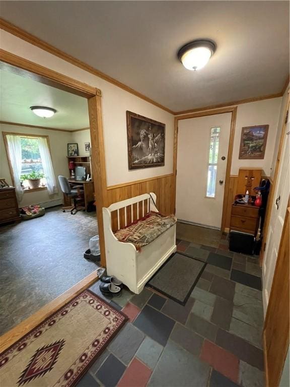 foyer entrance with wood walls and crown molding