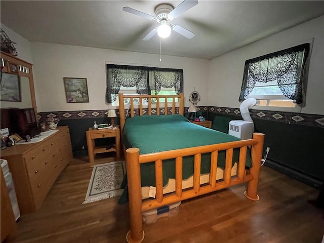 bedroom with ceiling fan and dark wood-type flooring