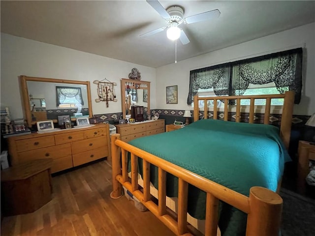 bedroom with multiple windows, ceiling fan, and dark wood-type flooring