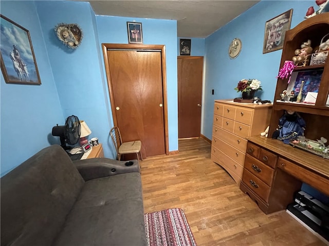 bedroom with light hardwood / wood-style flooring and a closet