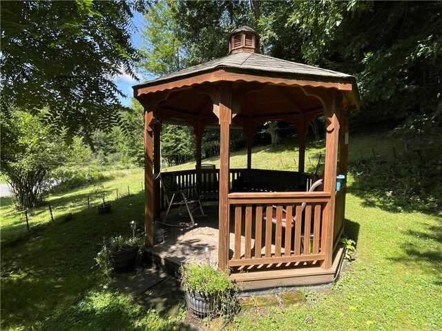 view of community featuring a gazebo, a yard, and fence