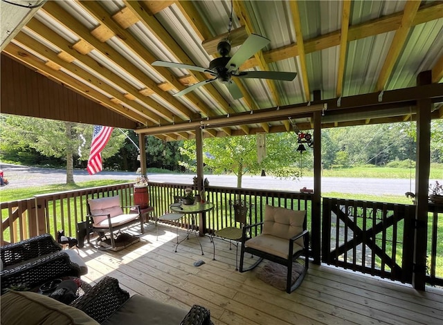 wooden terrace featuring a yard and ceiling fan