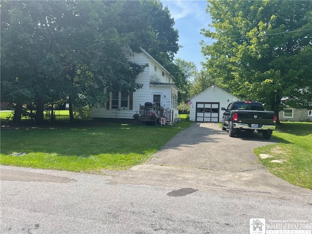 view of front facade with a garage, a front lawn, and an outdoor structure