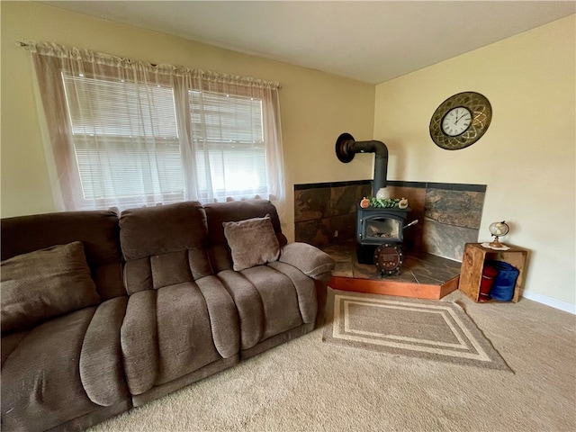 living room featuring a wood stove and carpet