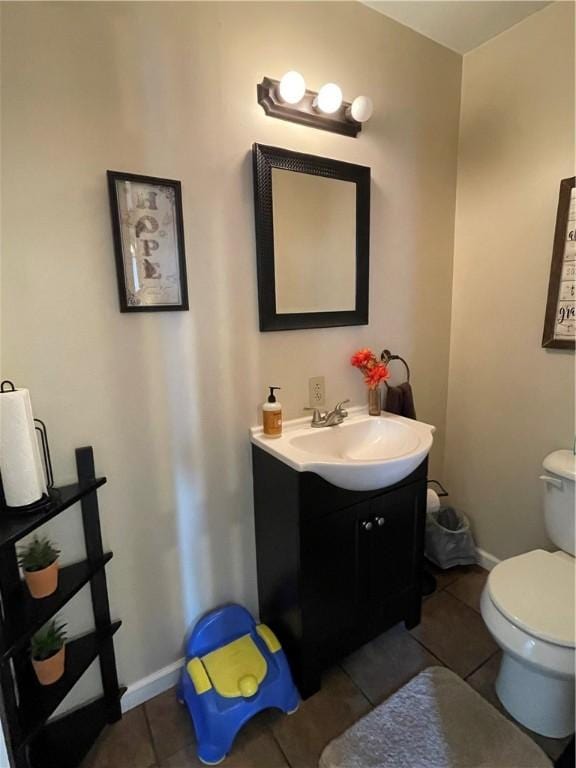 bathroom featuring vanity, toilet, and tile patterned flooring