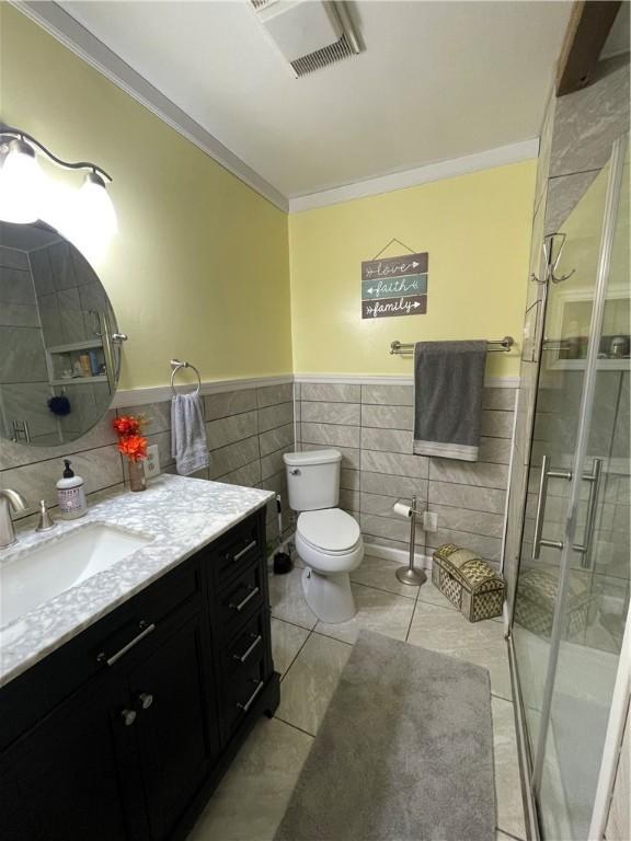 bathroom featuring walk in shower, toilet, ornamental molding, vanity, and tile patterned flooring