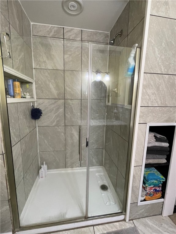 bathroom with a shower with shower door