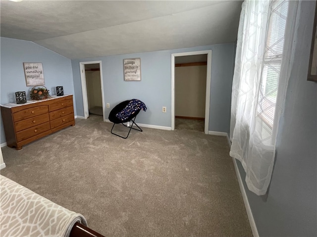 sitting room with light carpet and vaulted ceiling