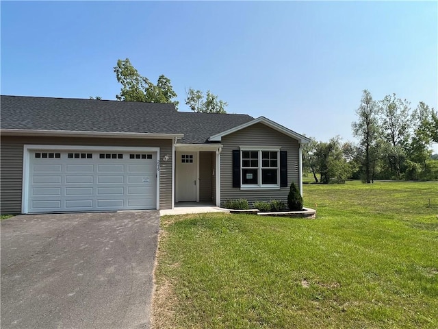 view of front of property featuring aphalt driveway, a garage, a front yard, and roof with shingles