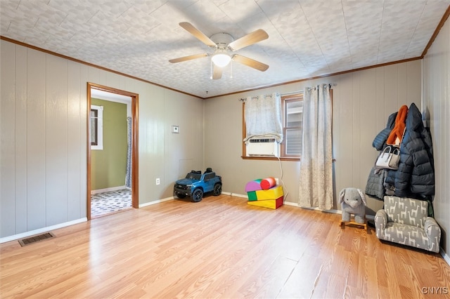 interior space with light hardwood / wood-style flooring, ceiling fan, and ornamental molding