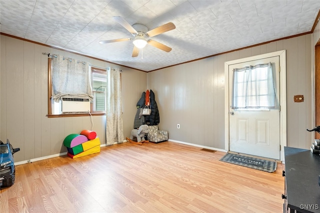 entryway featuring ceiling fan, light wood-type flooring, cooling unit, and ornamental molding