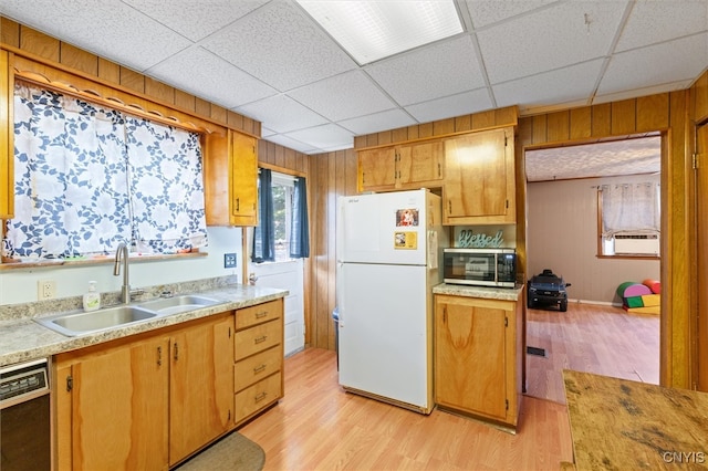 kitchen with light hardwood / wood-style floors, sink, white refrigerator, and dishwasher