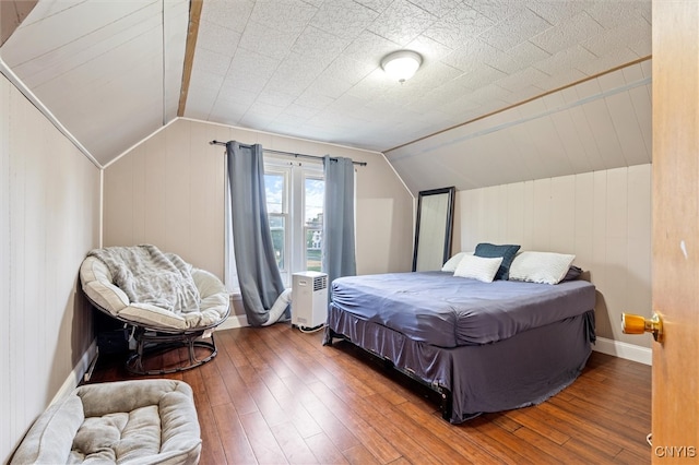 bedroom featuring vaulted ceiling and hardwood / wood-style floors