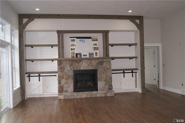 unfurnished living room featuring dark hardwood / wood-style flooring and a fireplace