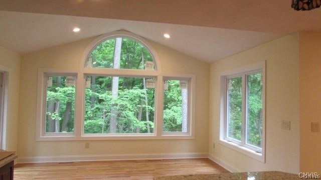 interior space with lofted ceiling and light wood-type flooring